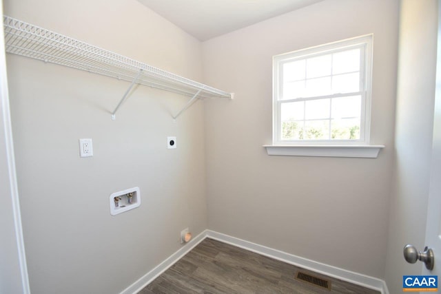 laundry room featuring dark wood-type flooring, hookup for a washing machine, and hookup for an electric dryer