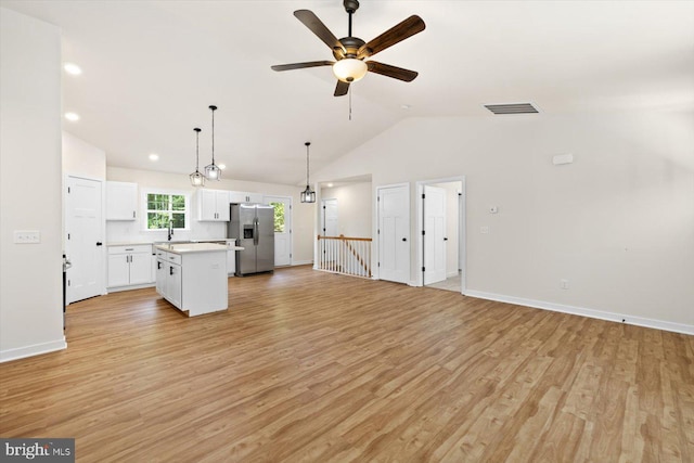 unfurnished living room featuring lofted ceiling, ceiling fan, and light wood-type flooring