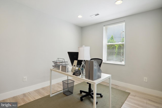 office with light wood-type flooring