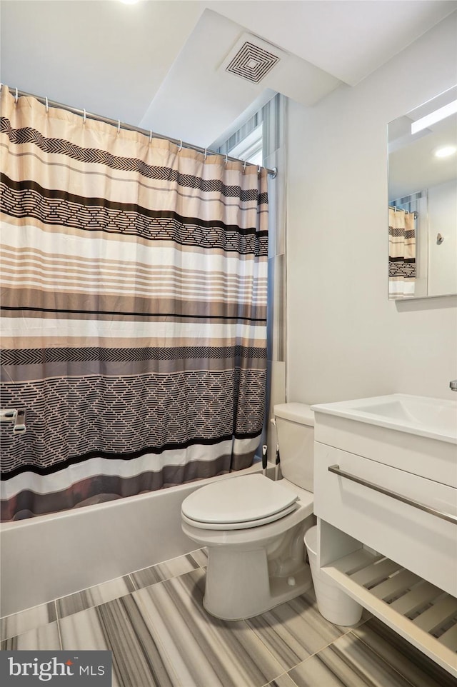 full bathroom featuring vanity, toilet, and shower / tub combo with curtain