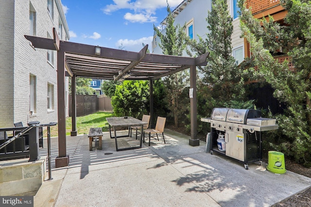 view of patio with area for grilling and a pergola