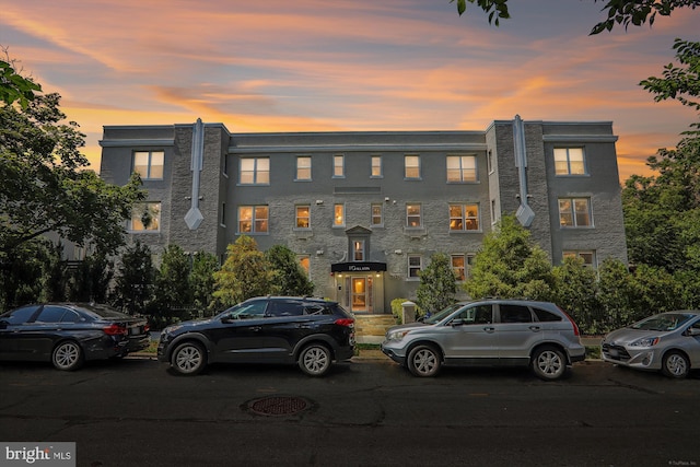 view of outdoor building at dusk