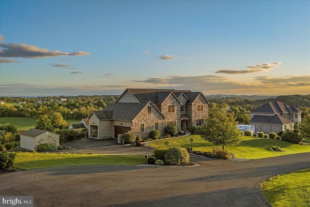 view of front of property featuring a lawn and a garage