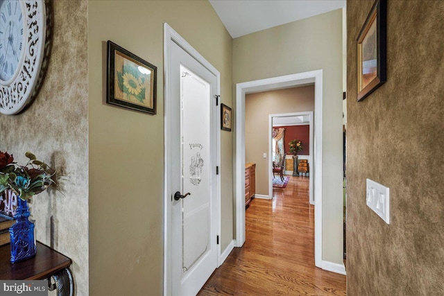 corridor with hardwood / wood-style floors