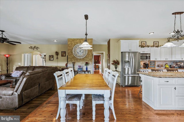 dining space featuring hardwood / wood-style flooring and ceiling fan