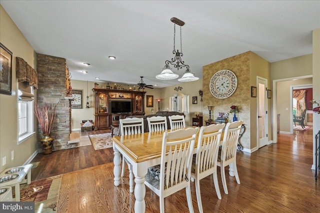 dining space featuring ceiling fan and dark hardwood / wood-style floors