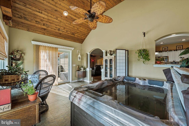 tiled living room featuring ceiling fan, high vaulted ceiling, and wood ceiling