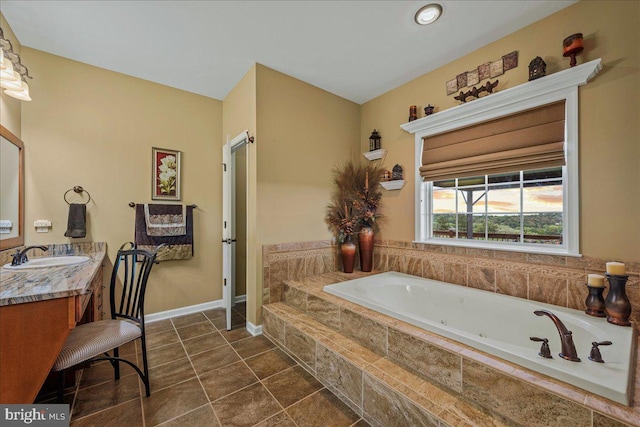 bathroom featuring a relaxing tiled tub, tile patterned flooring, and vanity