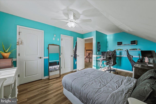 bedroom featuring ceiling fan, vaulted ceiling, and wood-type flooring