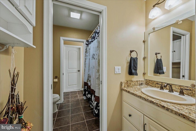 bathroom with tile patterned floors, vanity, and toilet