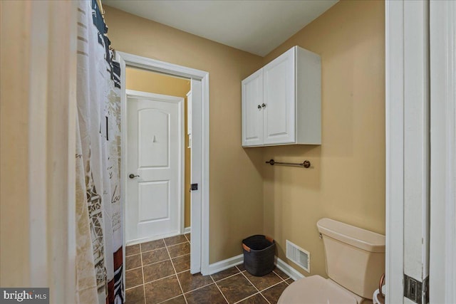 laundry room featuring dark tile patterned flooring