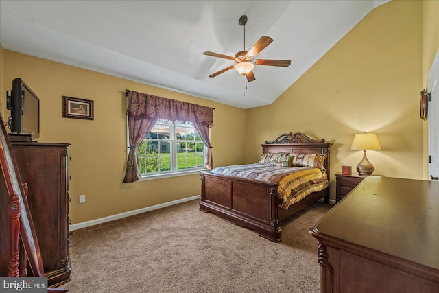 carpeted bedroom with ceiling fan and vaulted ceiling