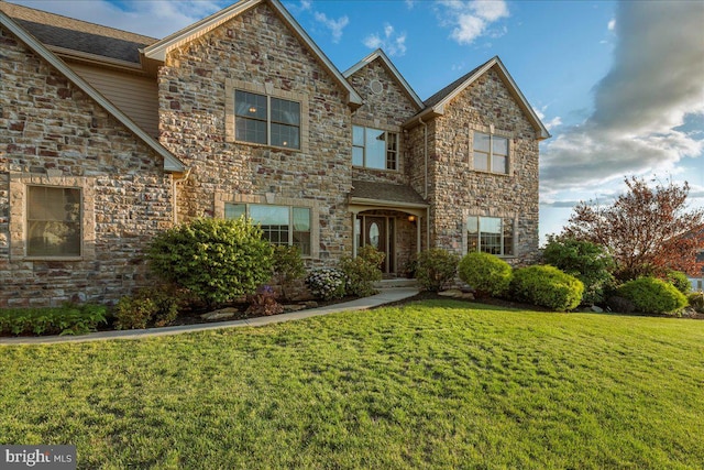 view of property featuring a front lawn