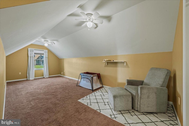 sitting room with ceiling fan, light colored carpet, and lofted ceiling