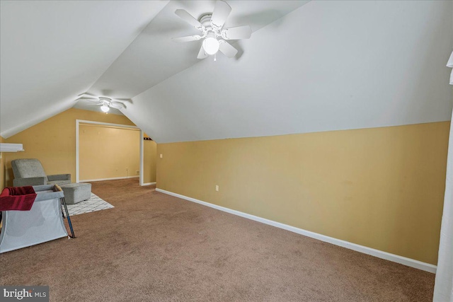 bonus room with ceiling fan, vaulted ceiling, and carpet flooring