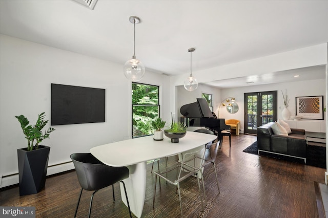 dining space with dark wood-type flooring, baseboard heating, and french doors