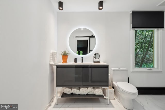 bathroom featuring toilet, vanity, and a baseboard radiator