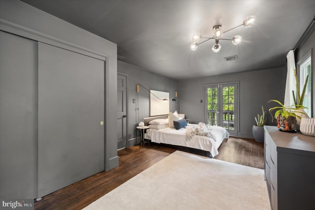 bedroom featuring access to outside and dark hardwood / wood-style flooring