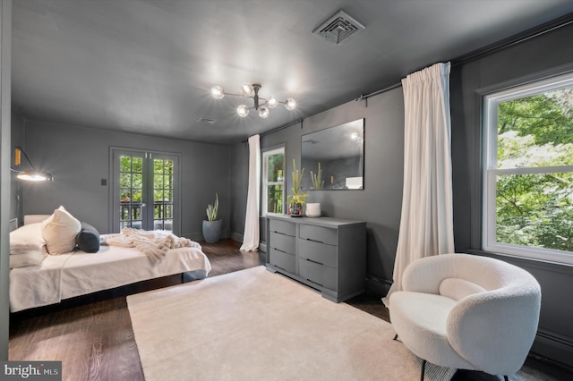 bedroom with a baseboard radiator, a chandelier, dark hardwood / wood-style flooring, and french doors