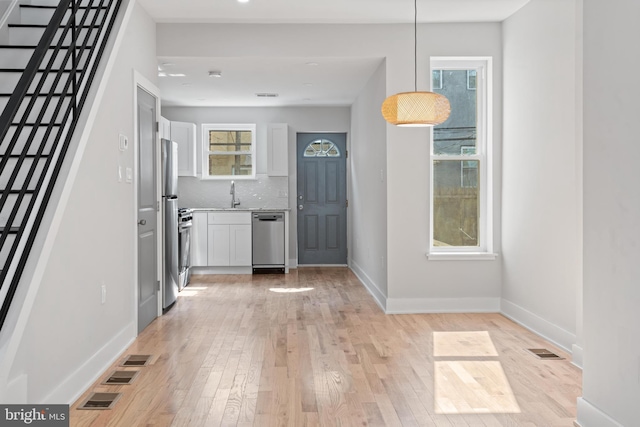 interior space featuring sink and light wood-type flooring