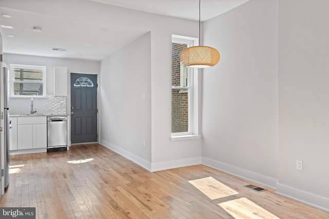 foyer with light wood-type flooring and sink