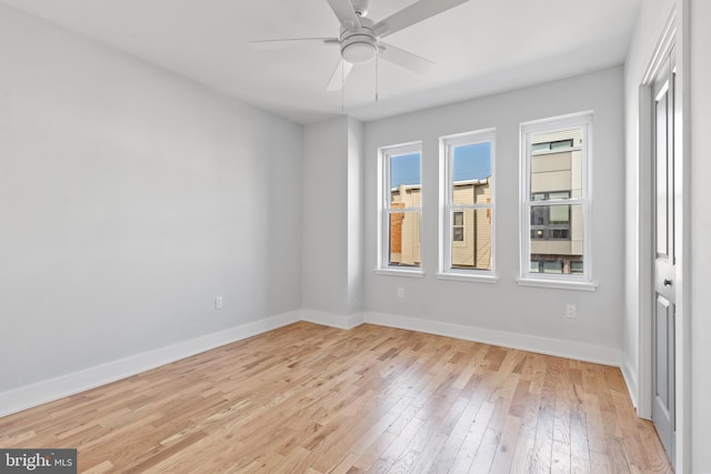 spare room with light hardwood / wood-style flooring and ceiling fan