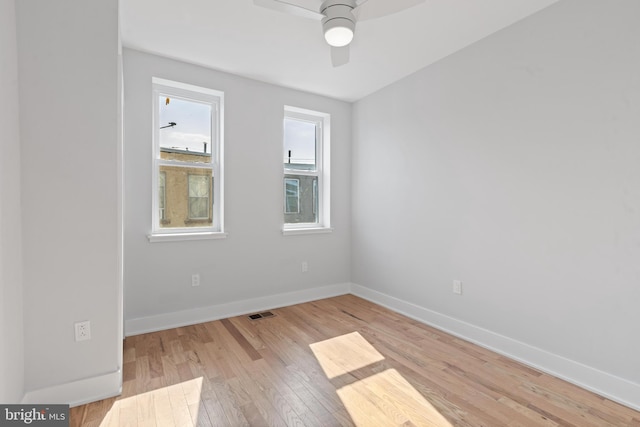 unfurnished room featuring light wood-type flooring and ceiling fan