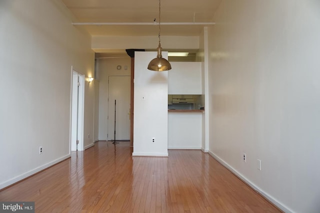 unfurnished dining area featuring wood-type flooring