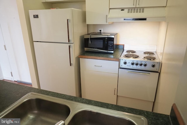 kitchen featuring sink, white appliances, and white cabinets