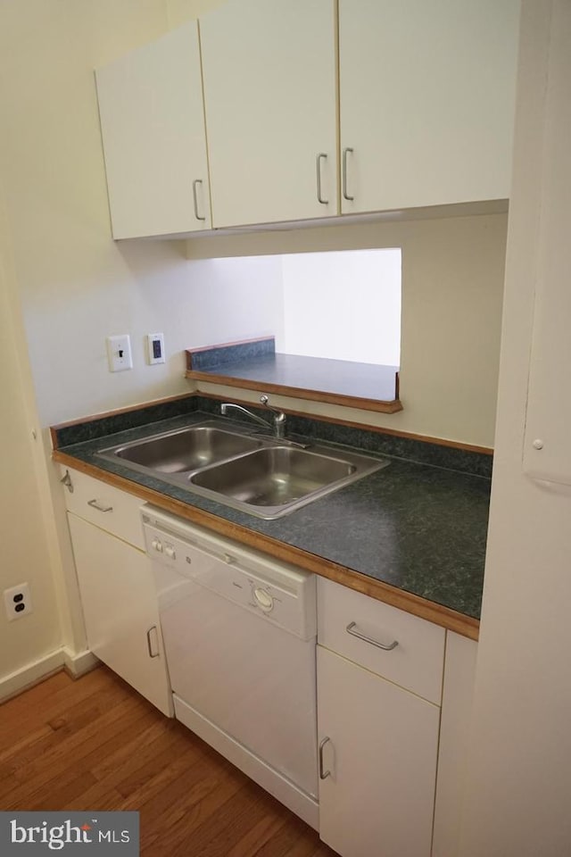 kitchen with sink, white cabinets, light hardwood / wood-style flooring, and white dishwasher