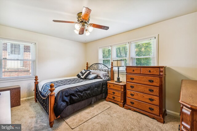 bedroom with ceiling fan and light carpet