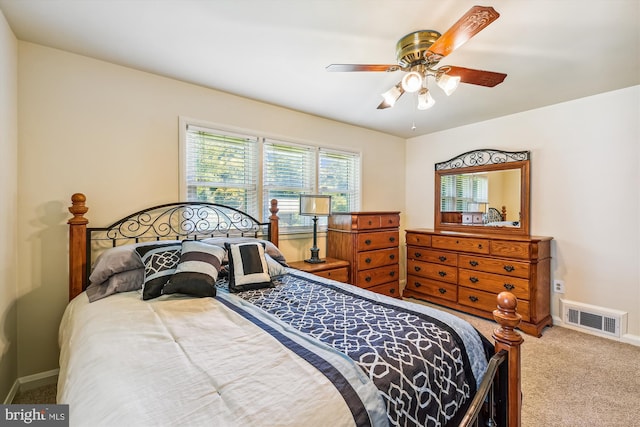 bedroom featuring light colored carpet, visible vents, ceiling fan, and baseboards