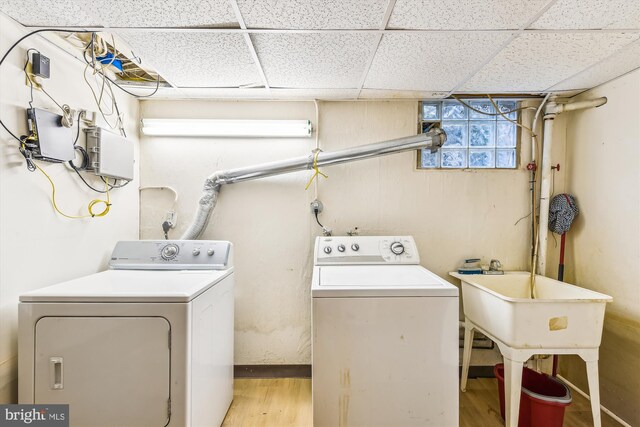 laundry room with light hardwood / wood-style flooring and washer and clothes dryer