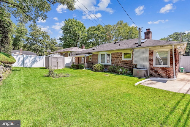 back of property with an outbuilding, a shed, a chimney, and brick siding