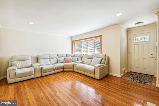 living area featuring recessed lighting, baseboards, crown molding, and light wood finished floors