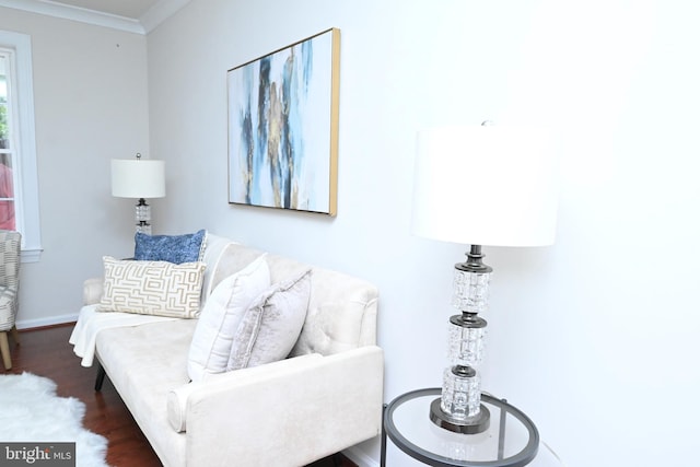 living room with dark wood-type flooring and crown molding