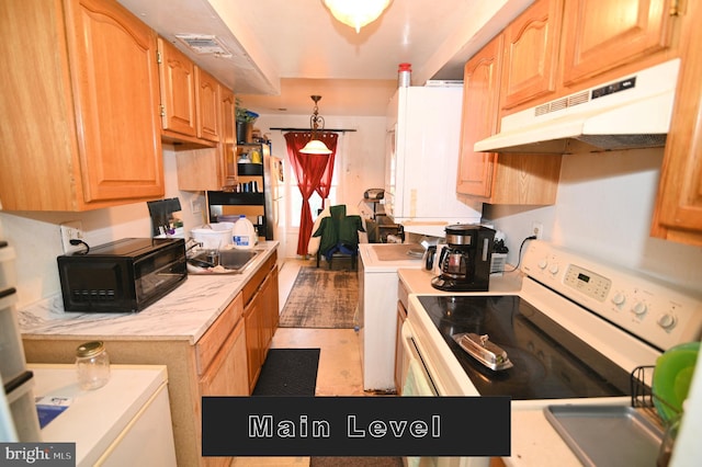 kitchen featuring washer / clothes dryer, electric stove, and light tile patterned floors