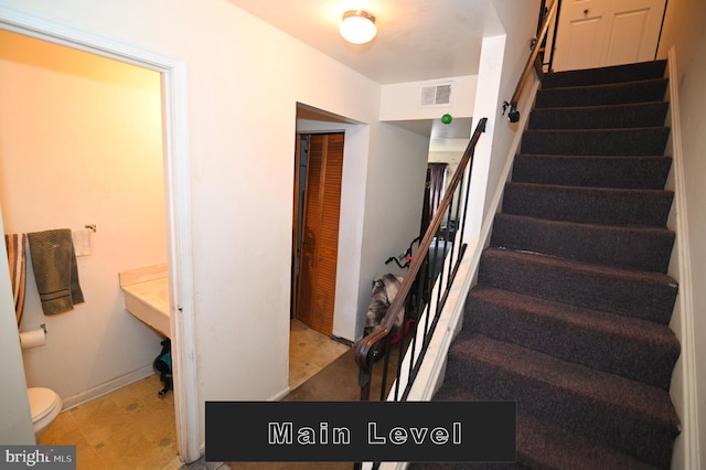 staircase with tile patterned floors