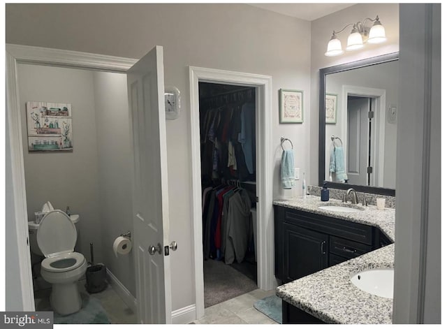 bathroom with vanity, toilet, and tile patterned floors