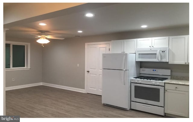 kitchen with white cabinets, dark hardwood / wood-style floors, white appliances, and ceiling fan