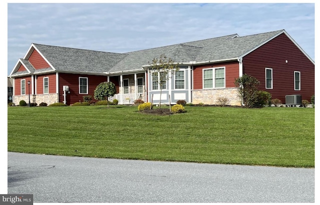 single story home featuring central air condition unit and a front lawn