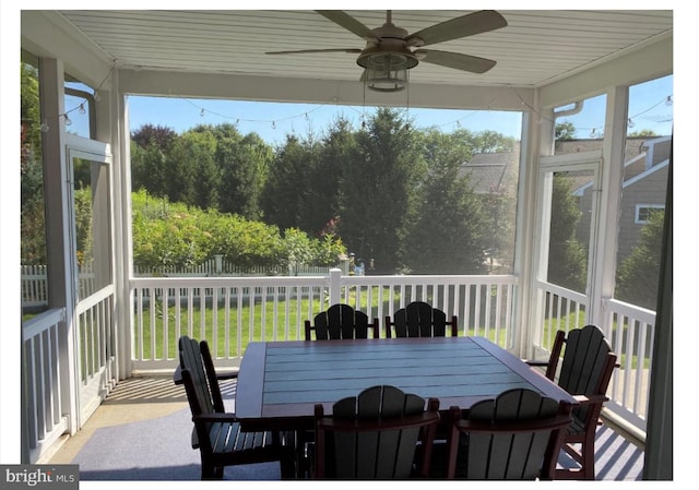 sunroom / solarium featuring ceiling fan