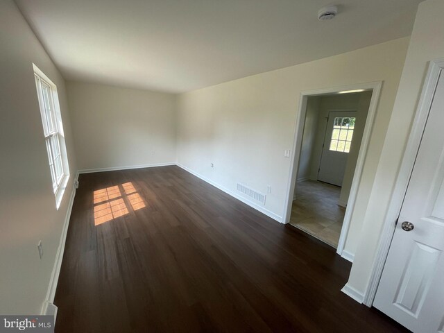 unfurnished room featuring dark hardwood / wood-style flooring