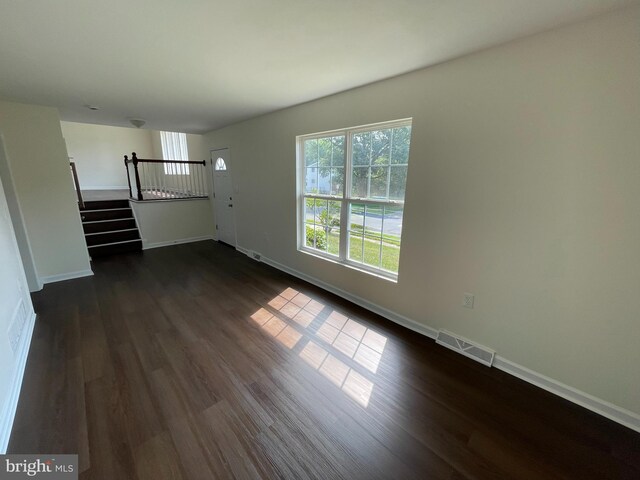 unfurnished bedroom featuring dark hardwood / wood-style flooring