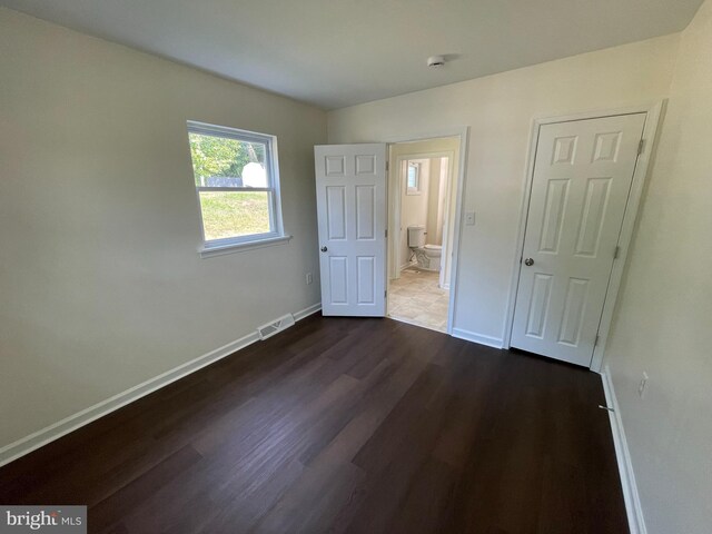 unfurnished bedroom with hardwood / wood-style flooring