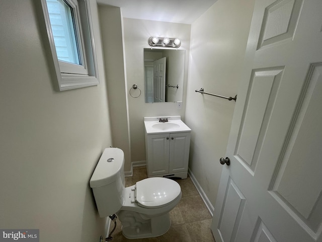 bathroom featuring tile patterned flooring, vanity, and toilet