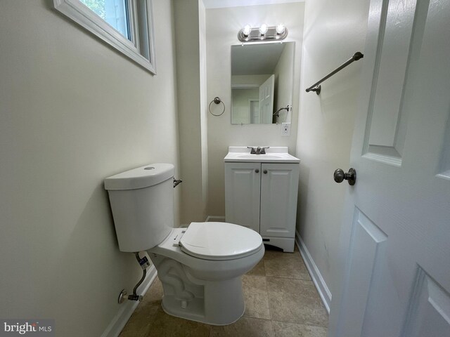 bathroom with tile patterned floors, toilet, and vanity