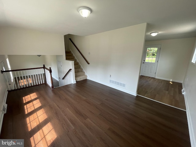 spare room featuring dark wood-type flooring