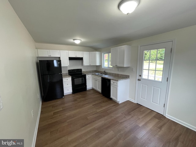 kitchen featuring dark hardwood / wood-style flooring, white cabinets, sink, black appliances, and lofted ceiling