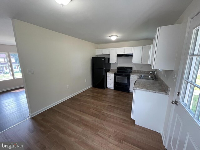 kitchen featuring sink, white cabinetry, black appliances, and dark hardwood / wood-style floors